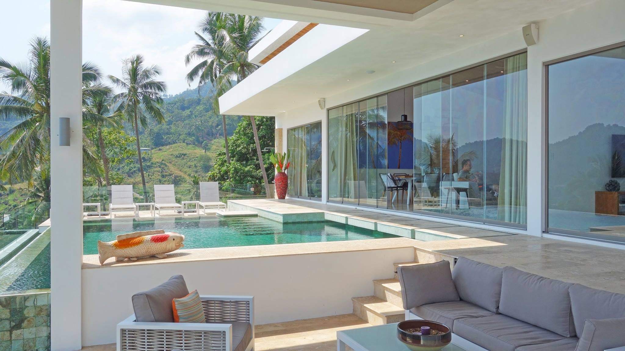 Poolside terrace opening to a glazed living pavilion, HAMPKON villa, Koh Samui