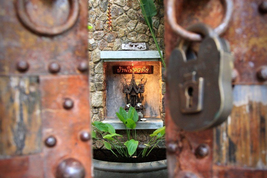 Hand-finished teak door and stone detail — HAMPKON craftsmanship, Koh Samui