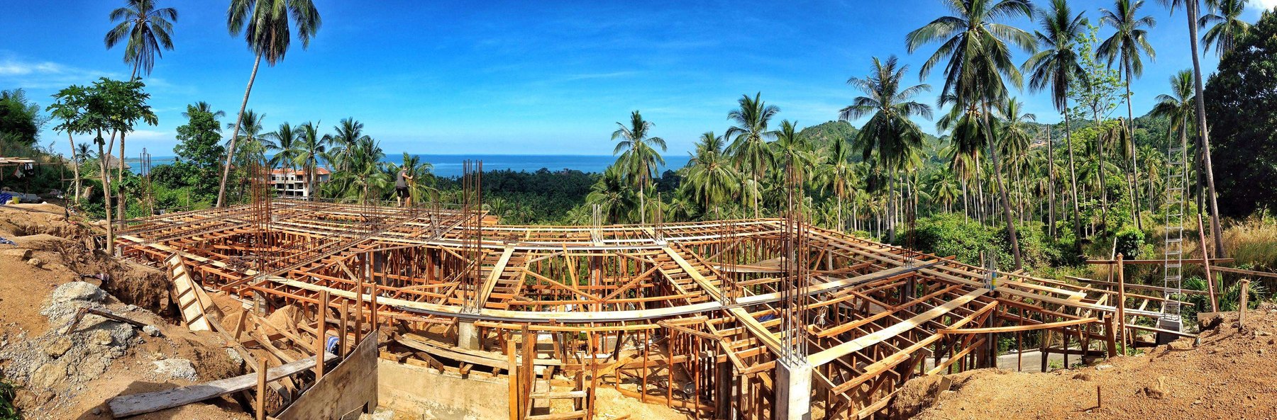 Wide construction view of Aruna's structural frame on the hillside