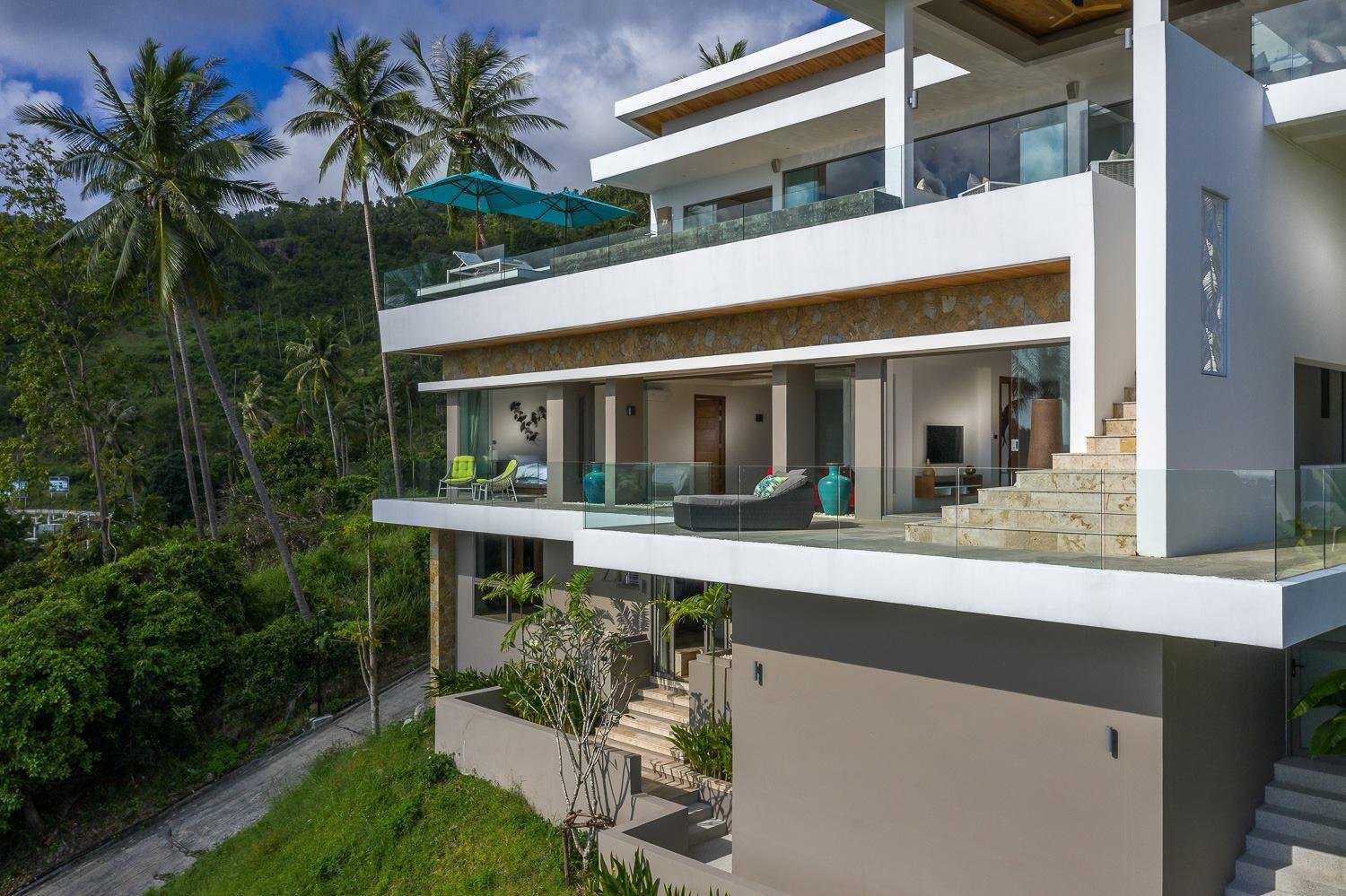 Aerial side view of Aruna's stacked terraces, Koh Samui