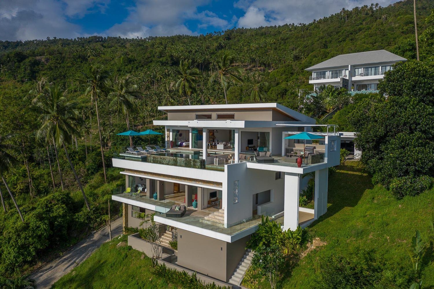 Aruna at twilight — multi-level hillside villa with cascading infinity pools, Koh Samui