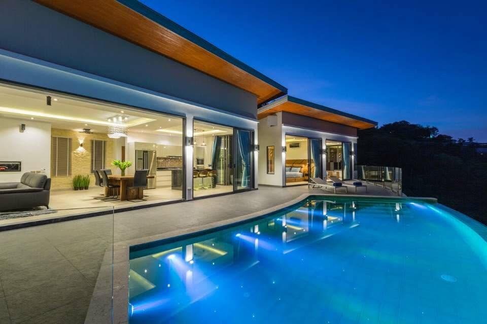 Victoria at dusk — illuminated infinity pool and hillside residence, Koh Samui